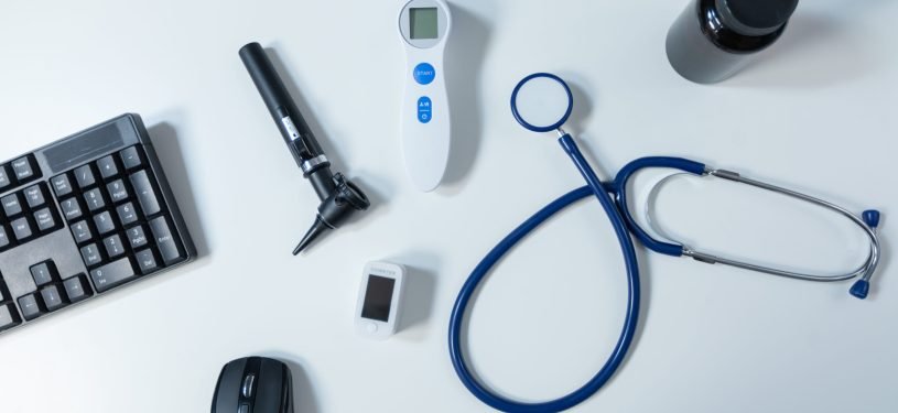 Top view of medical professional instruments standing on table in empty modern doctor office ready for health care consultation. Hospital workplace equipped with examination tools. Medicine support